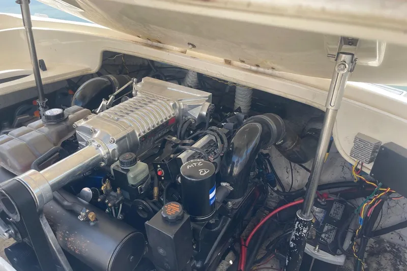 Slide: The Image of Engine compartment of a 2001 Rinker 262 Captiva boat, showcasing detailed mechanical components. - 20