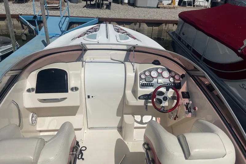Slide: The Image of 2001 Rinker 262 Captiva boat interior with steering wheel and dashboard controls. - 4