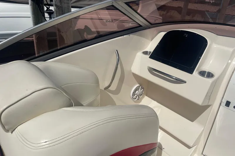 Slide: The Image of Interior of a 2001 Rinker 262 Captiva boat with white seating and dashboard. - 8