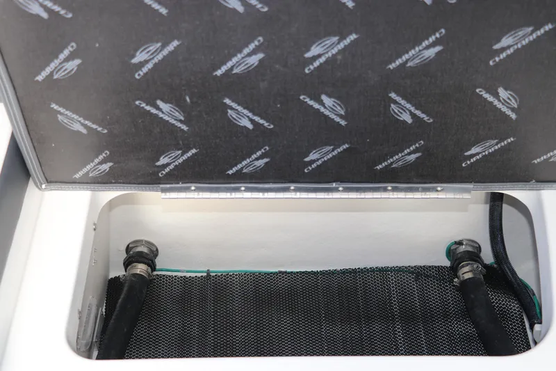 Slide: The Image of Storage compartment of 2026 Chaparral 270 OSX boat, featuring branded interior lining. - 11