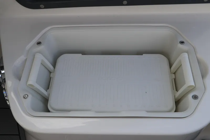 Slide: The Image of Built-in cooler on 2026 Chaparral 270 OSX boat, featuring a white Igloo cooler. - 14