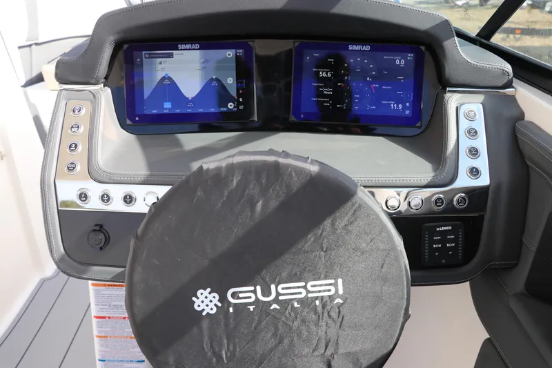 Slide: The Image of 2026 Chaparral 270 OSX dashboard with dual Simrad displays and Gussi Italia steering wheel. - 20