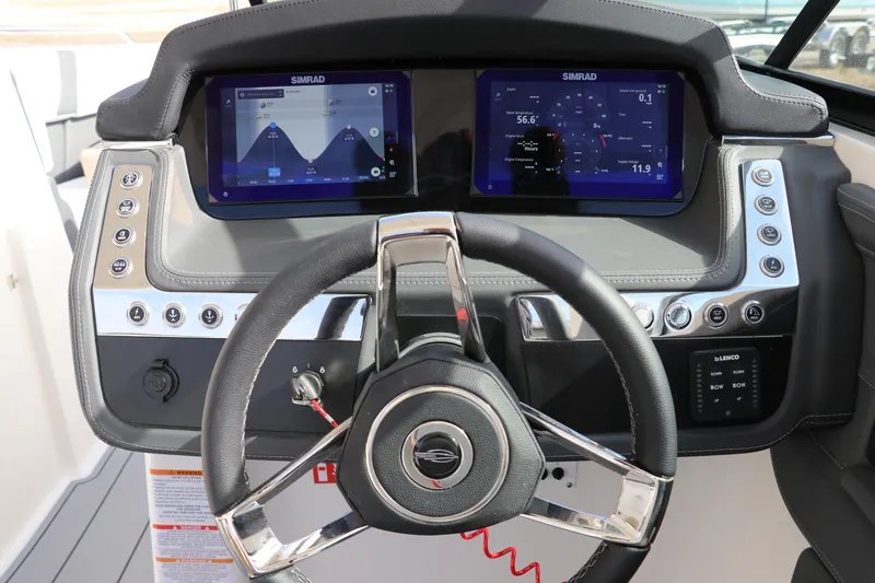 Slide: The Image of 2026 Chaparral 270 OSX boat dashboard with dual Simrad displays and modern controls. - 21
