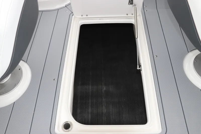 Slide: The Image of 2026 Chaparral 270 OSX boat storage compartment with open hatch on deck. - 25