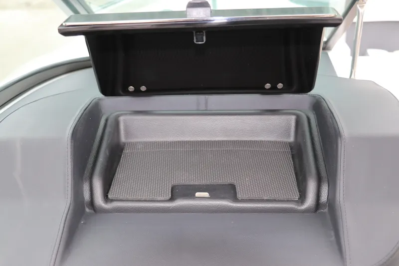 Slide: The Image of Storage compartment in 2026 Chaparral 270 OSX boat dashboard. - 30