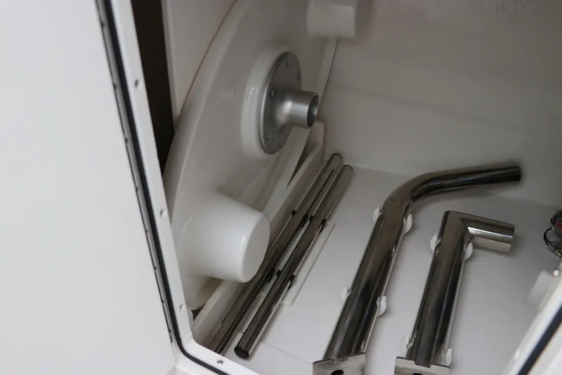 Slide: The Image of Storage compartment with metal parts in 2026 Chaparral 270 OSX boat. - 36