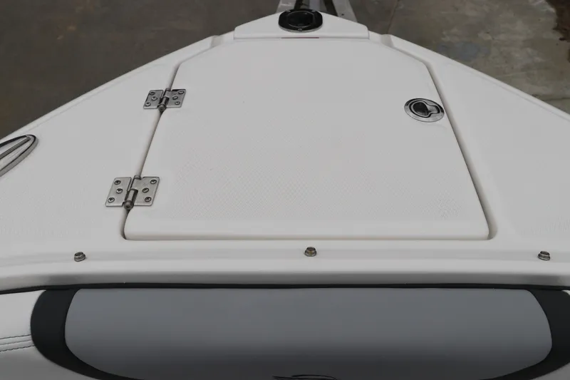Slide: The Image of Bow storage compartment of 2026 Chaparral 270 OSX boat, featuring stainless steel hinges. - 52