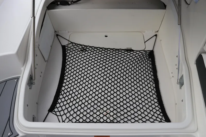 Slide: The Image of Storage compartment with netting in 2026 Chaparral 270 OSX boat. - 9