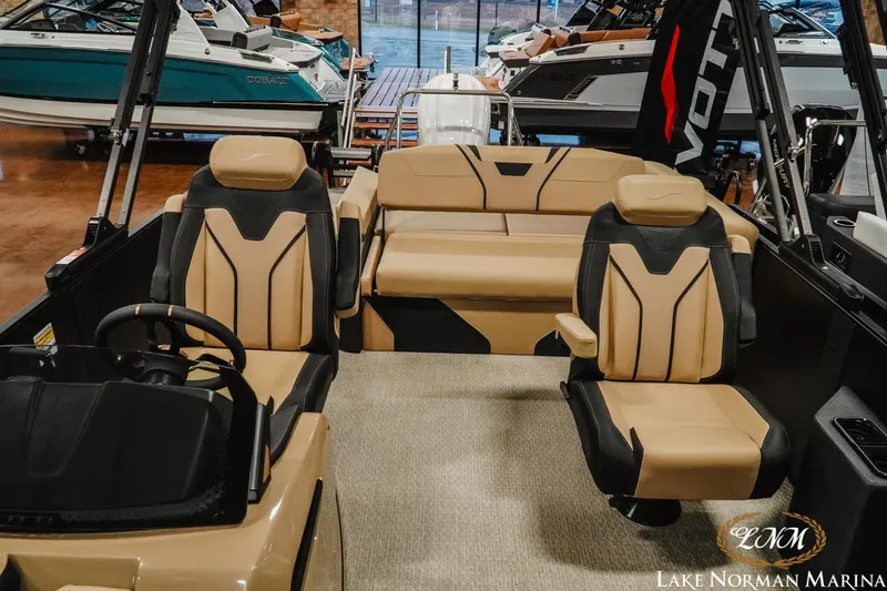 Slide: The Image of 2026 Evotti 725CS boat interior with tan and black seating at Lake Norman Marina. - 13