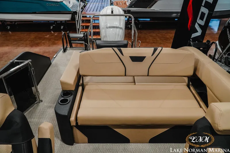 Slide: The Image of Evotti 725CS 2026 boat interior with beige seating and cup holders at Lake Norman Marina. - 15