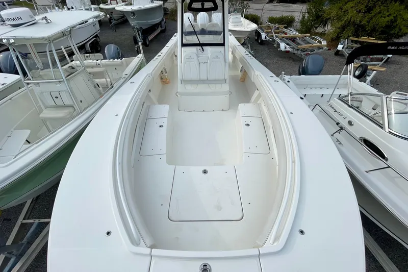 Slide: The Image of 2023 Regulator 34 boat, spacious deck, surrounded by other boats in a marina. - 12