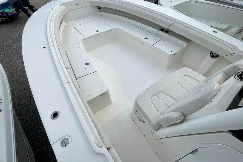 Slide: The Image of 2023 Regulator 34 boat interior with white seating and storage compartments. - 14