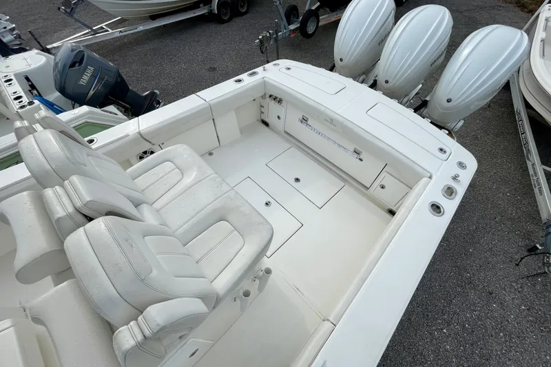 Slide: The Image of 2023 Regulator 34 boat with triple outboard engines and spacious seating area. - 16