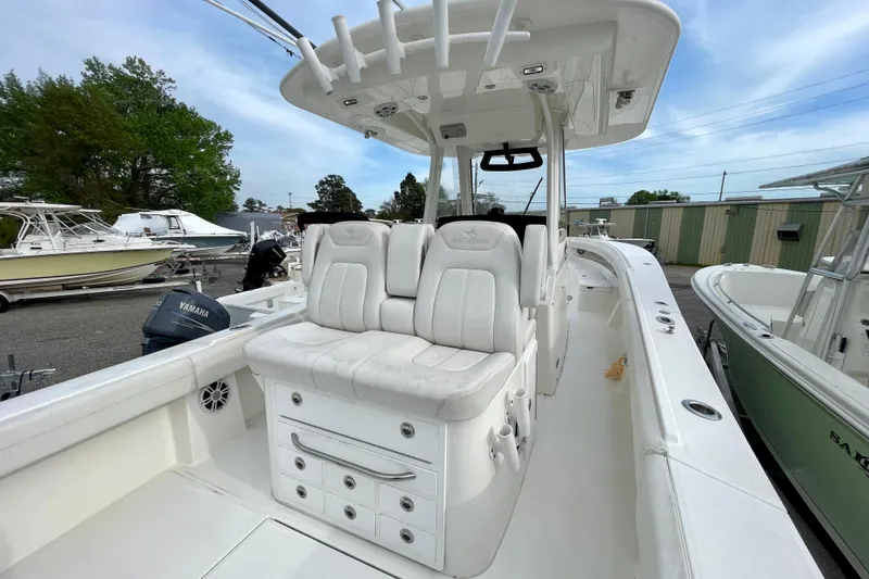 Slide: The Image of 2023 Regulator 34 boat interior with white seating and storage compartments. - 19