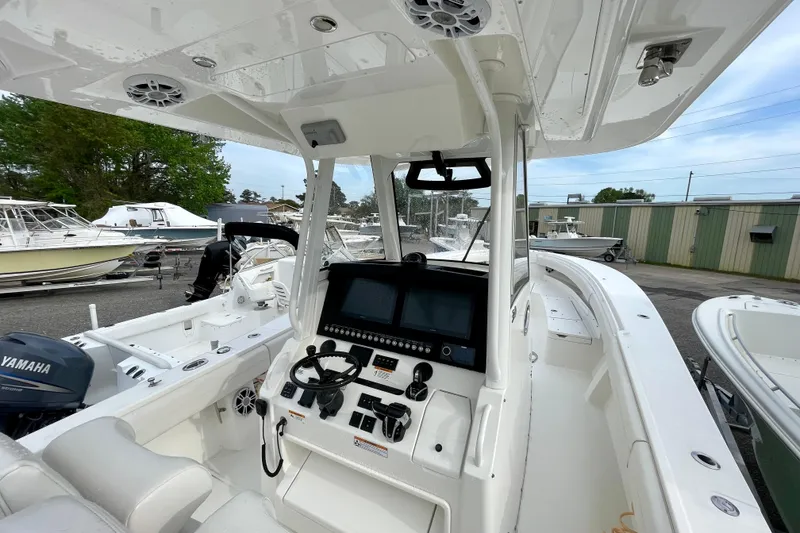 Slide: The Image of 2023 Regulator 34 boat cockpit with advanced navigation system and Yamaha engine. - 23