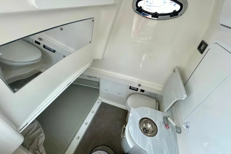 Slide: The Image of 2023 Regulator 34 boat interior with compact bathroom and sink. - 29