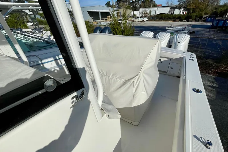 Slide: The Image of 2023 Regulator 34 boat with covered seating, docked outdoors. - 5