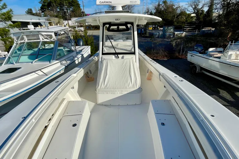 Slide: The Image of 2023 Regulator 34 boat with spacious deck and modern design in a marina setting. - 6