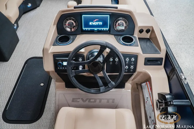 Slide: The Image of Evotti 523CS 2026 boat dashboard with steering wheel and digital display at Lake Norman Marina. - 11