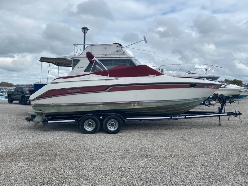 The Image of 1992 Regal Ventura boat on a trailer in a marina. - 1
