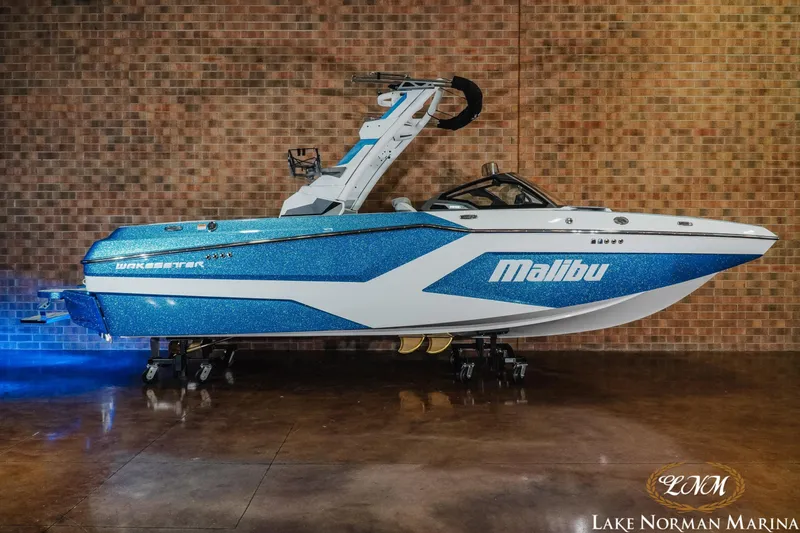 The Image of 2026 Malibu Wakesetter 22 MXZ boat with blue and white design at Lake Norman Marina. - 1