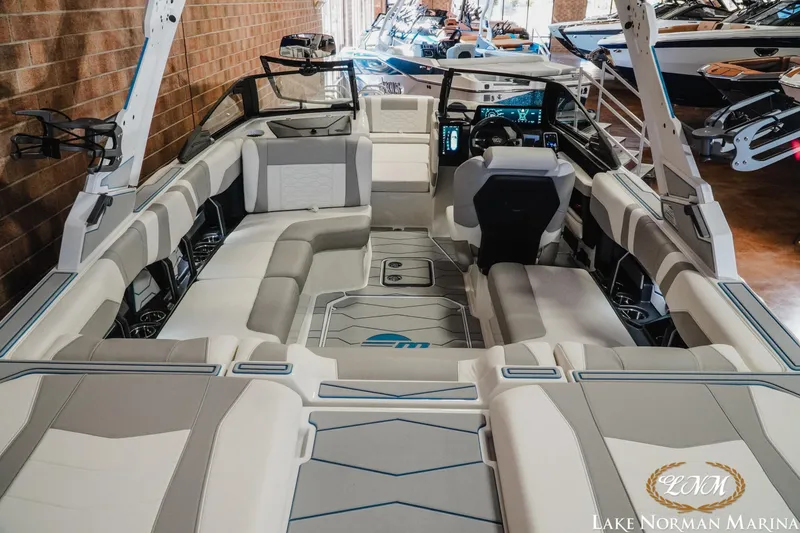 Slide: The Image of 2026 Malibu Wakesetter 22 MXZ interior with luxurious seating at Lake Norman Marina. - 12
