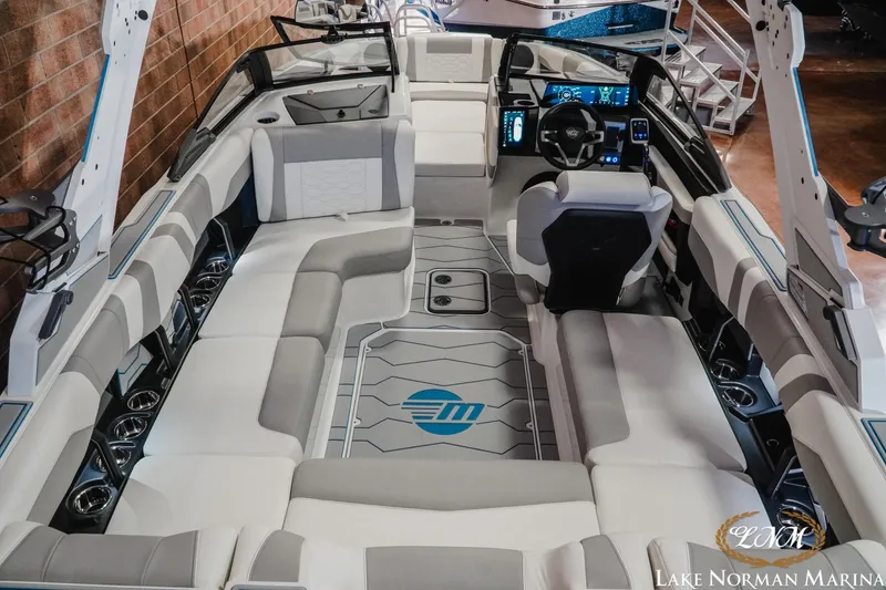 Slide: The Image of 2026 Malibu Wakesetter 22 MXZ interior with modern seating and advanced dashboard controls. - 13