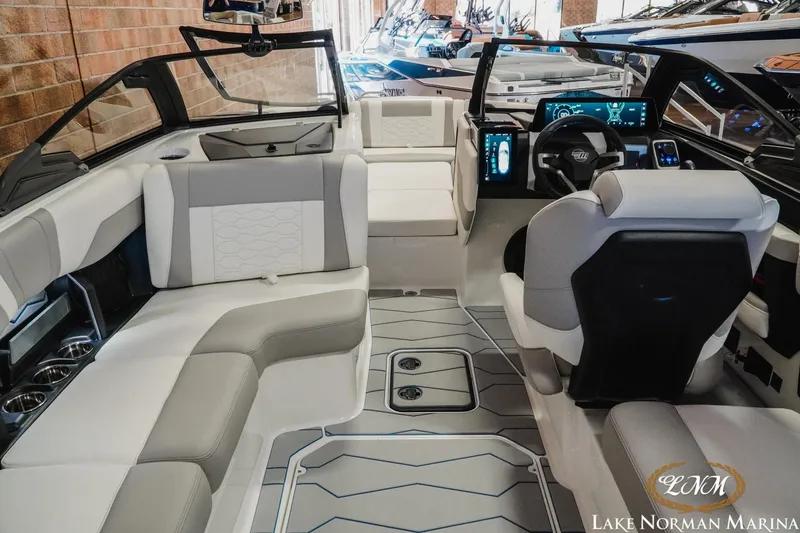 Slide: The Image of 2026 Malibu Wakesetter 22 MXZ interior with modern dashboard and seating at Lake Norman Marina. - 14