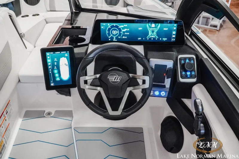 Slide: The Image of 2026 Malibu Wakesetter 22 MXZ dashboard with advanced digital controls and steering wheel. - 16