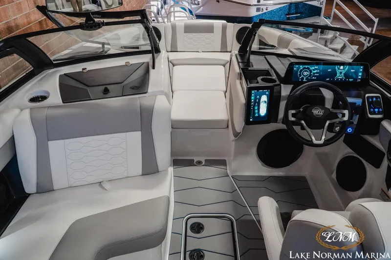 Slide: The Image of 2026 Malibu Wakesetter 22 MXZ interior with modern dashboard and seating at Lake Norman Marina. - 18