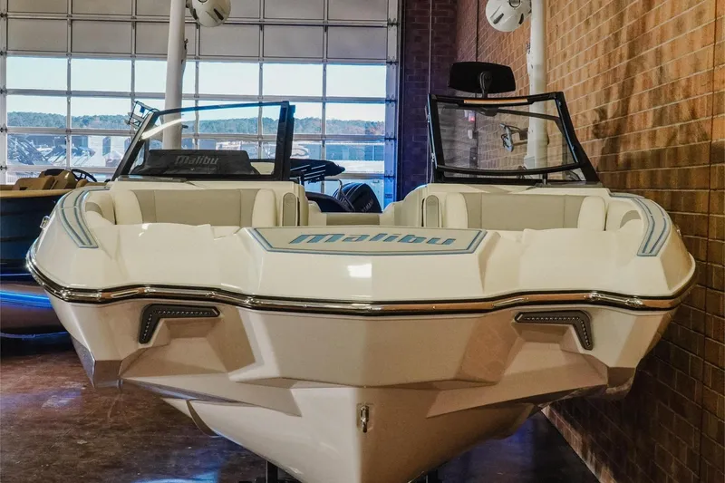 Slide: The Image of 2026 Malibu Wakesetter 22 MXZ boat displayed indoors, showcasing sleek design and luxury features. - 4