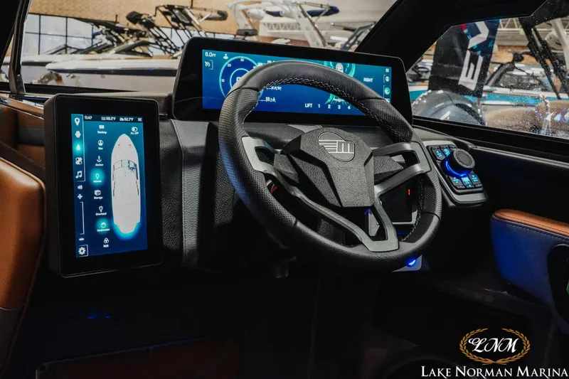 Slide: The Image of 2026 Malibu Wakesetter 23 LSV dashboard with advanced digital controls and steering wheel. - 14