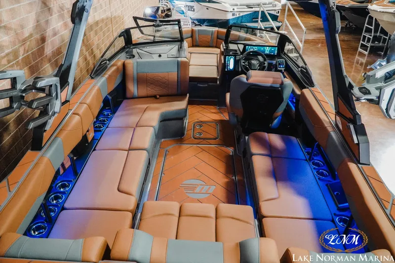 Slide: The Image of 2026 Malibu Wakesetter 23 LSV interior with luxurious seating and modern dashboard at Lake Norman Marina. - 16