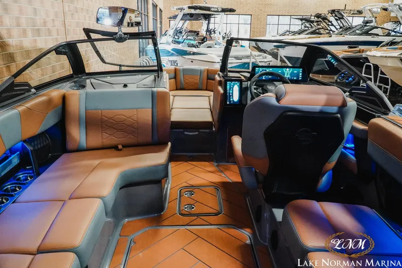 Slide: The Image of 2026 Malibu Wakesetter 23 LSV interior with luxurious seating and modern dashboard at Lake Norman Marina. - 17