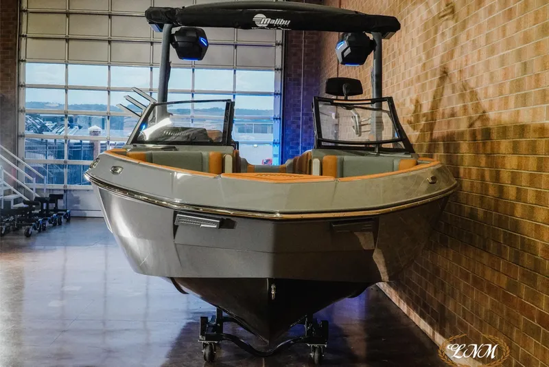 Slide: The Image of 2026 Malibu Wakesetter 23 LSV boat in showroom, front view, sleek design. - 22