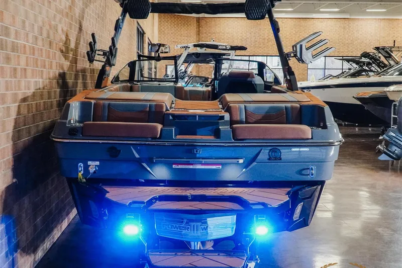 Slide: The Image of 2026 Malibu Wakesetter 23 LSV boat with illuminated blue lights in showroom. - 23