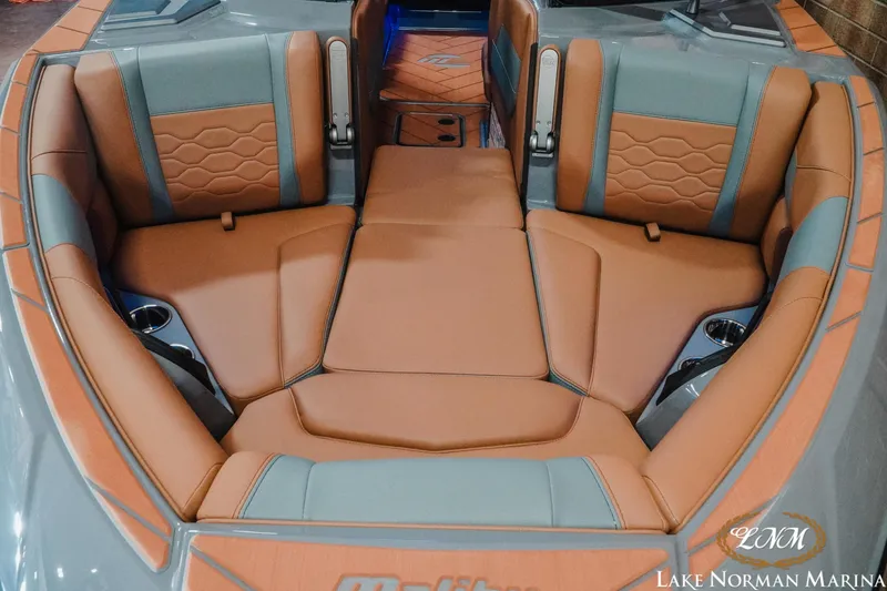 Slide: The Image of 2026 Malibu Wakesetter 23 LSV interior with tan and gray seating, cup holders, and logo. - 3
