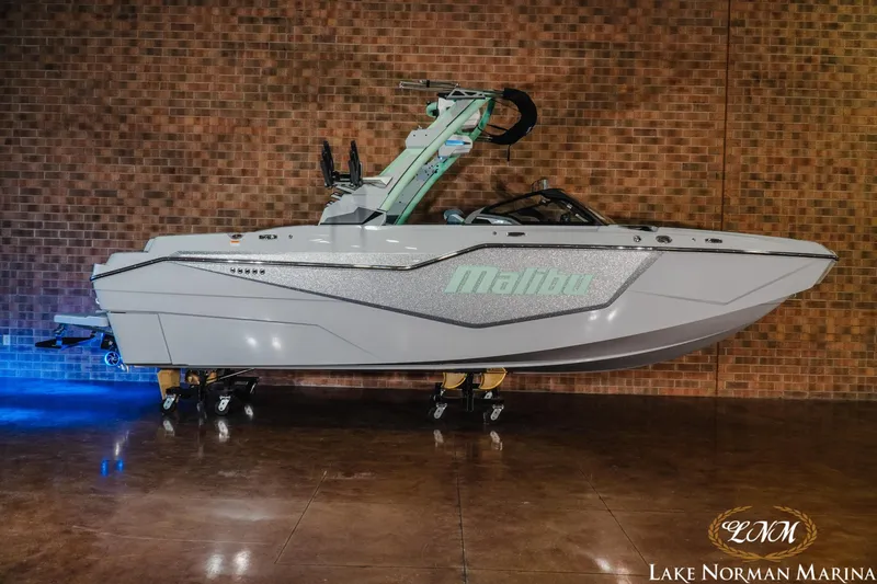The Image of 2026 Malibu M230 boat displayed at Lake Norman Marina, side view. - 1