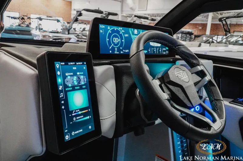Slide: The Image of Dashboard of 2026 Malibu M230 boat with advanced digital displays and steering wheel. - 14