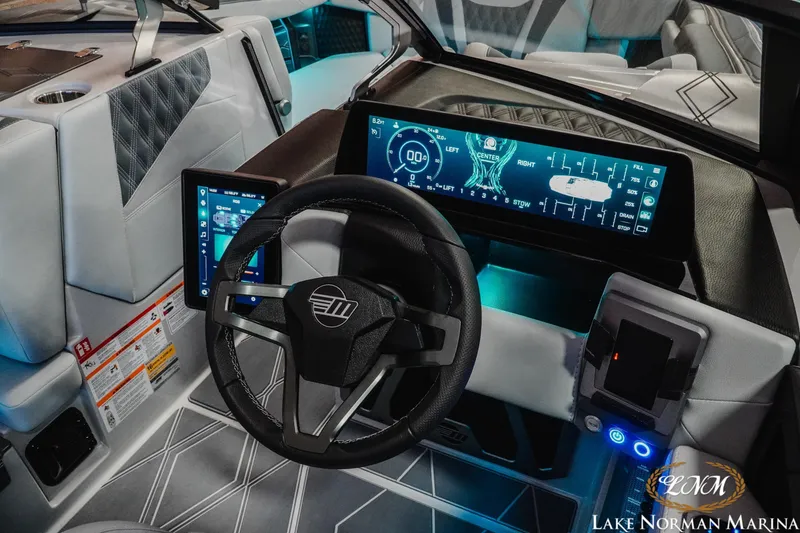 Slide: The Image of Interior of 2026 Malibu M230 boat with advanced digital dashboard and steering wheel. - 15
