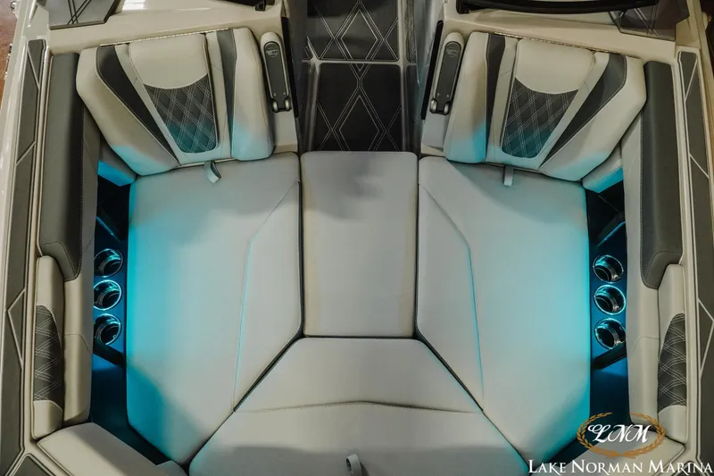 Slide: The Image of 2026 Malibu M230 boat interior with illuminated seating and cup holders at Lake Norman Marina. - 18