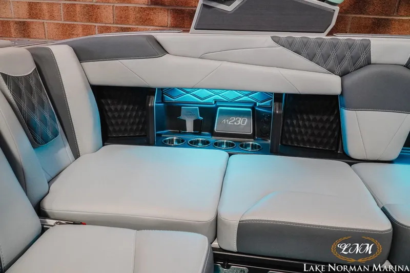 Slide: The Image of 2026 Malibu M230 boat interior with luxurious seating and ambient lighting. - 21