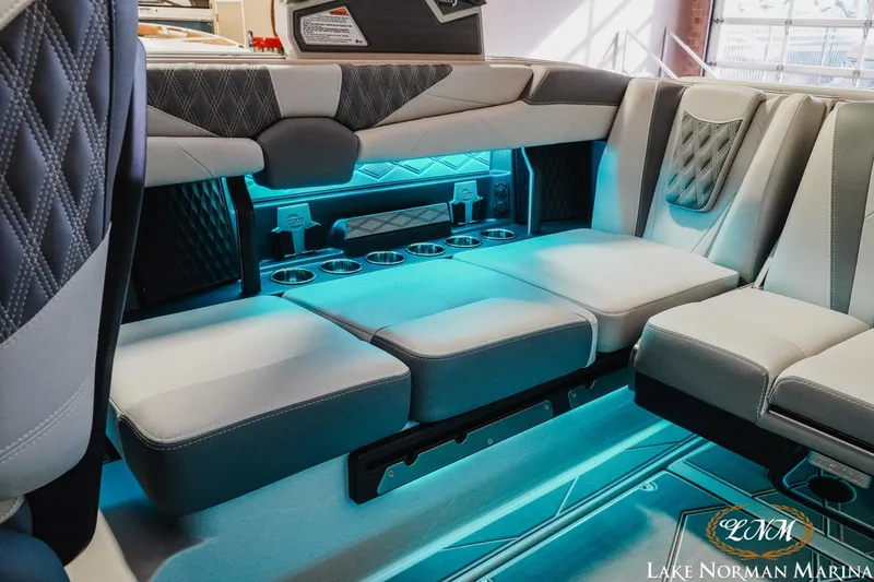 Slide: The Image of Luxurious interior of 2026 Malibu M230 boat with ambient lighting and plush seating. - 23