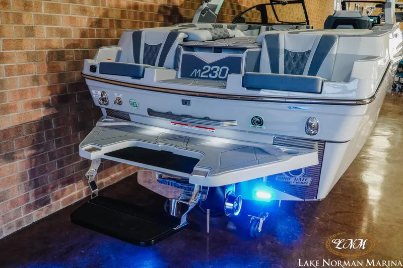 Slide: The Image of 2026 Malibu M230 boat with illuminated swim platform at Lake Norman Marina. - 6