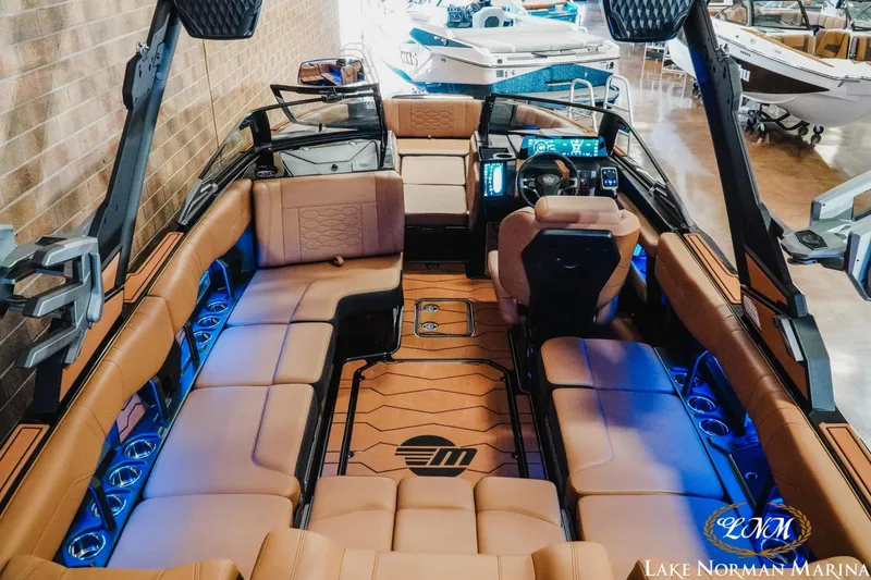 Slide: The Image of 2026 Malibu Wakesetter 23 MXZ interior with luxurious seating and modern dashboard at Lake Norman Marina. - 10