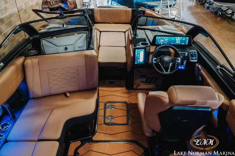 Slide: The Image of 2026 Malibu Wakesetter 23 MXZ interior with luxurious seating and advanced dashboard technology. - 12