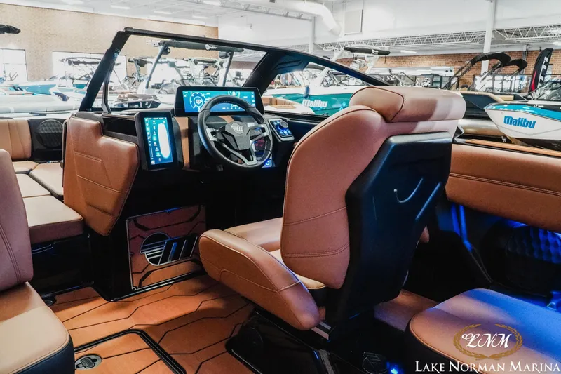 Slide: The Image of 2026 Malibu Wakesetter 23 MXZ interior with modern dashboard and luxurious seating. - 13