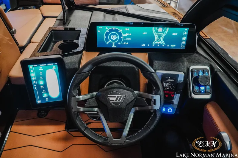 Slide: The Image of 2026 Malibu Wakesetter 23 MXZ dashboard with advanced digital displays and controls. - 15