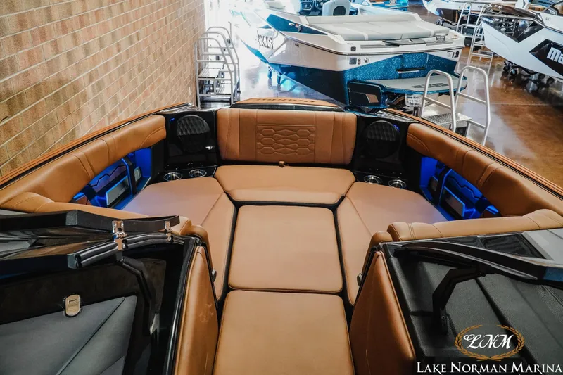Slide: The Image of 2026 Malibu Wakesetter 23 MXZ interior with luxurious tan seating at Lake Norman Marina. - 16