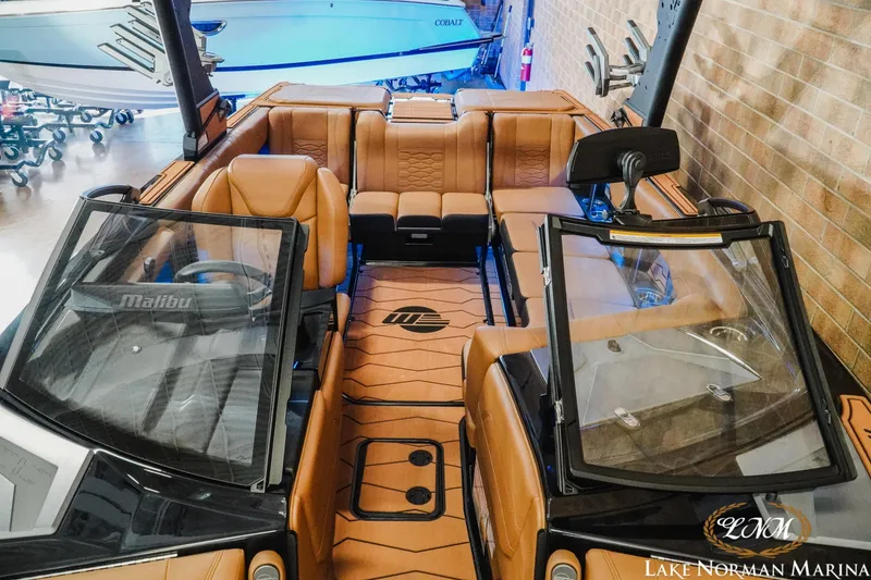 Slide: The Image of 2026 Malibu Wakesetter 23 MXZ interior with luxurious tan seating at Lake Norman Marina. - 17